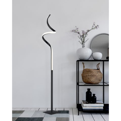 Black metal display shelf next to rug on floor