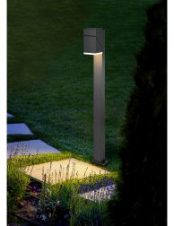 marble path of square tiles illuminated by a lantern made of met