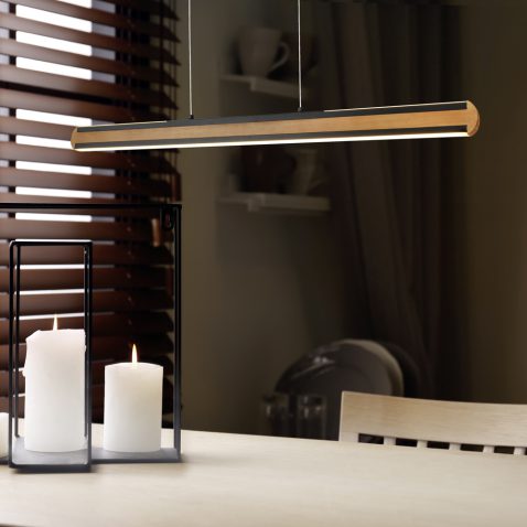 Wooden dining table with candles in room. Interior design