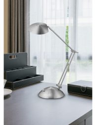 wooden table with white coffee cup and reading lamp in modern wo