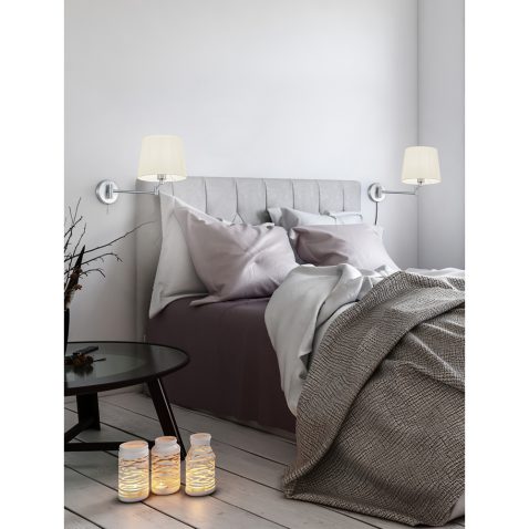 Single bed in room with radiators under windows