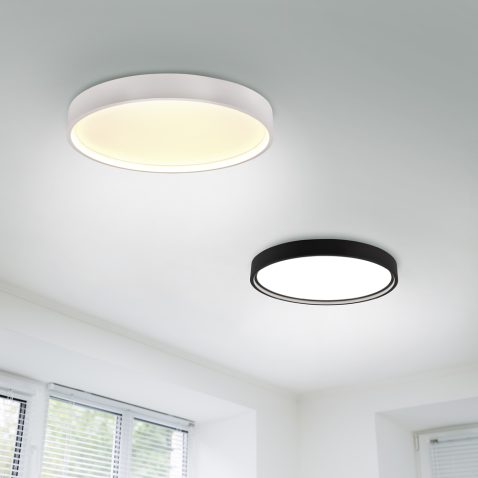 Suspended ceiling with modern LED lighting. Turned on lamps on the ceiling in office of white colours