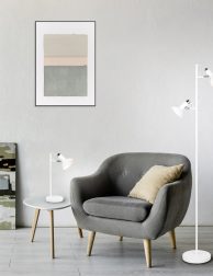 comfortable armchair near coffee table with green plants, lamp a