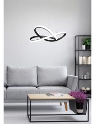 Flowers in wooden table in front of grey settee in modern simple