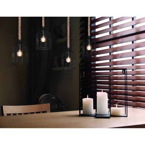 Wooden dining table with candles in room. Interior design