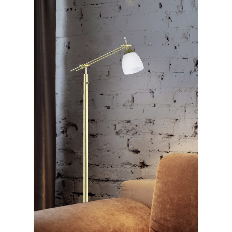 Golden floor lamp and orange comfortable sofa in an elegant living room interior with a brick wall