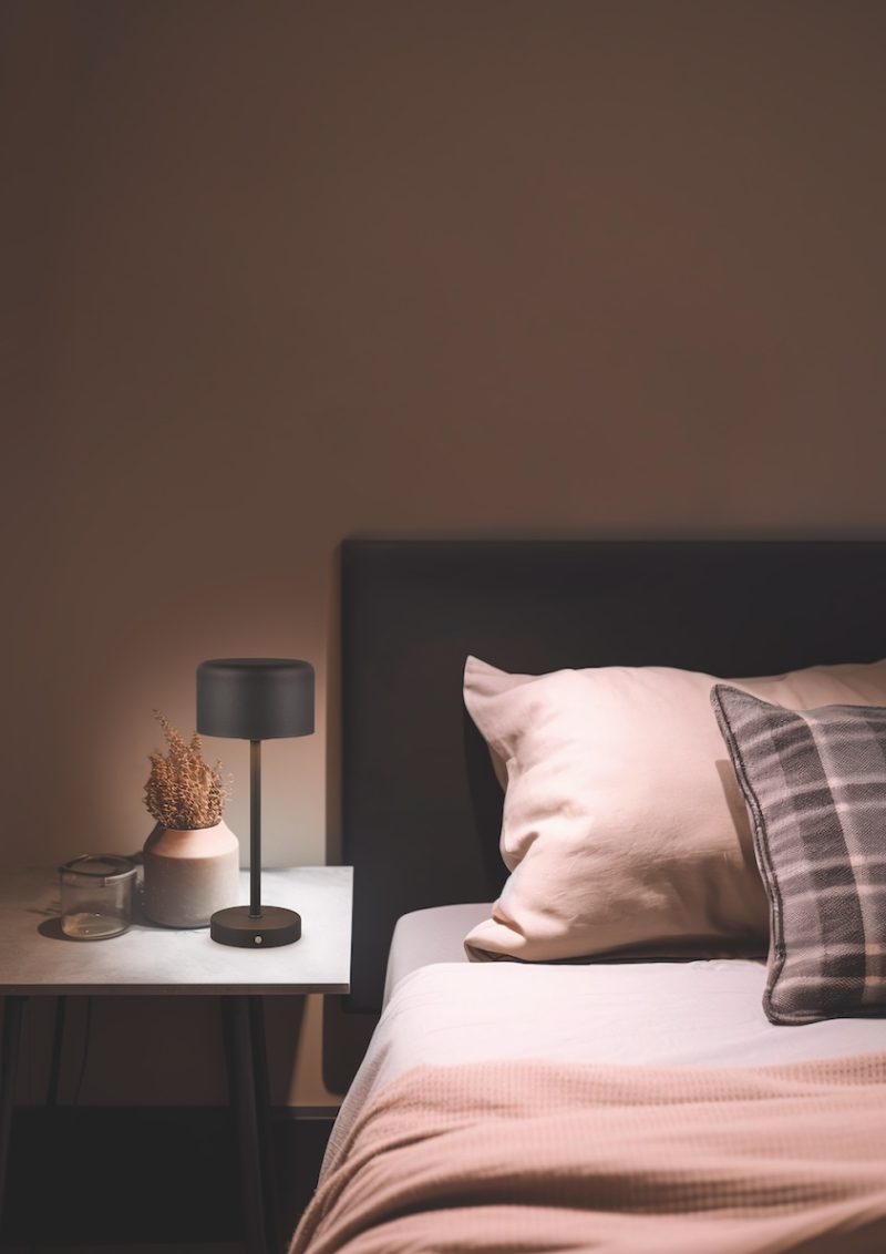 Bedroom interior with pillows and a lamp on the bedside table